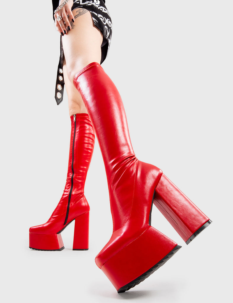 Not Your Basic Boots Return The Favour Platform Knee High Boots in Red faux leather. These platform boots feature a minimalist design, with a stretchy fitted feel, the perfect pair with any outfit. Made with eco-friendly materials and 100% cruelty-free, these platform boots are as ethical as they are Cool! - Platform Height - Heel Height - Black Zipper - Fitted feel - Knee length - Platform sole - Shark's teeth grip - High Heel - 100% vegan SKU: LMF 2875 - RedPU