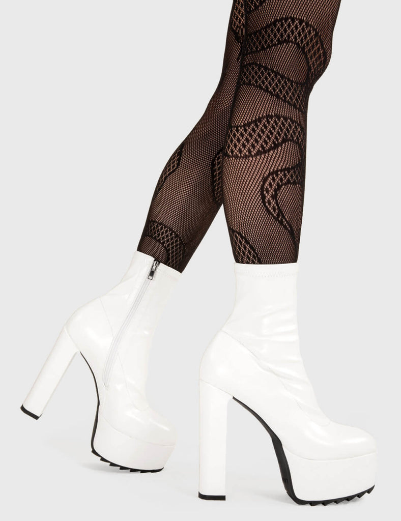 Not Your Basic Boots! Rule Over Platform Ankle Boots in White faux leather. These platform boots feature a minimalist design, with a fitted feel on our platform sole and high heel. Made with eco-friendly materials and 100% cruelty-free, these platform boots are as ethical as they are Trendy. - Platform Height - Heel Height - White zip - fitted feel - High Heel - Platform Sole - Shark's Teeth Grip - 100% vegan SKU: LMF 3109 - WhiteStretchPU