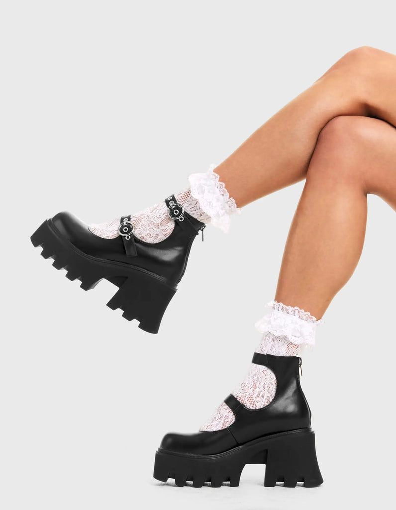 BUCKLED UP Slow Jamz Chunky Platform Ankle Boots in black faux leather. These platform boots feature two adjustable starps with silver buckles and eyelets. Made with eco-friendly materials and 100% cruelty-free, these platform boots are as ethical as they are chic. - Platform Height - Ankle length - Two adjustable straps - Silver buckles and eyelets - Rounded toe - High Heel - 100% vegan SKU: LMF 3600 - BlackPU