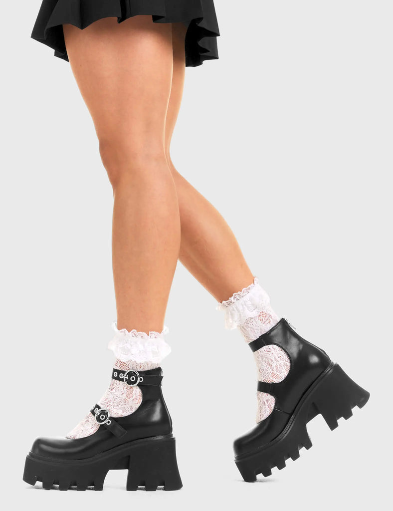 BUCKLED UP Slow Jamz Chunky Platform Ankle Boots in black faux leather. These platform boots feature two adjustable straps with silver buckles and eyelets. Made with eco-friendly materials and 100% cruelty-free, these platform boots are as ethical as they are chic. - Platform Height - Ankle length - Two adjustable straps - Silver buckles and eyelets - Rounded toe - High Heel - 100% vegan SKU: LMF 3600 - BlackPU