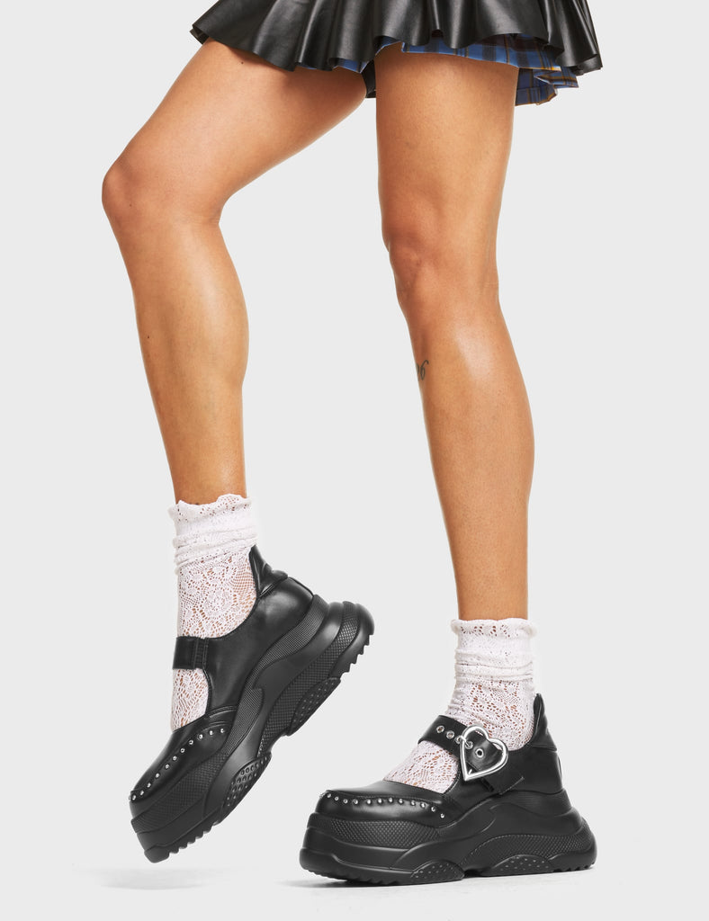 Sunny Side Chunky Platform Sneakers in Black faux leather. These Chunky Sneakers feature Mary Jane design with a thick strap over the foot and a silver heart-shaped buckle. They also feature silver stud detailing. Made with eco-friendly materials and 100% cruelty-free!