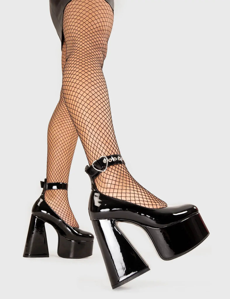 WISHLIST Those Days Platform Heels in Black patent. These platform boots feature a silver heart buckle with a flared heel, keeping it nice and classy. Made with eco-friendly materials and 100% cruelty-free, these platform boots are as ethical as they are chic. - Platform Height - Silver Heart buckles - Adjustable straps - Flared heel - High Heel - 100% vegan SKU: LMF 3344 - BlackPAT