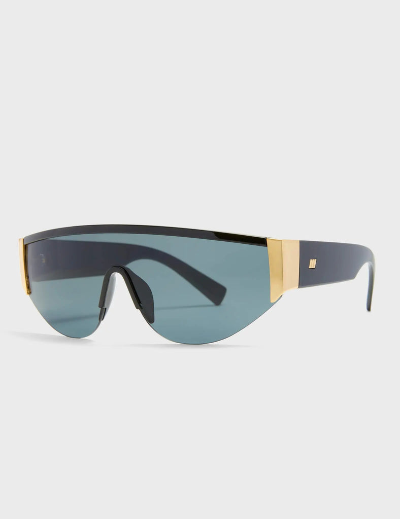 Throw Shade Visor Sunglasses. These Visor sunglasses feature Gold touches on the frame, and a Black tinted lens.