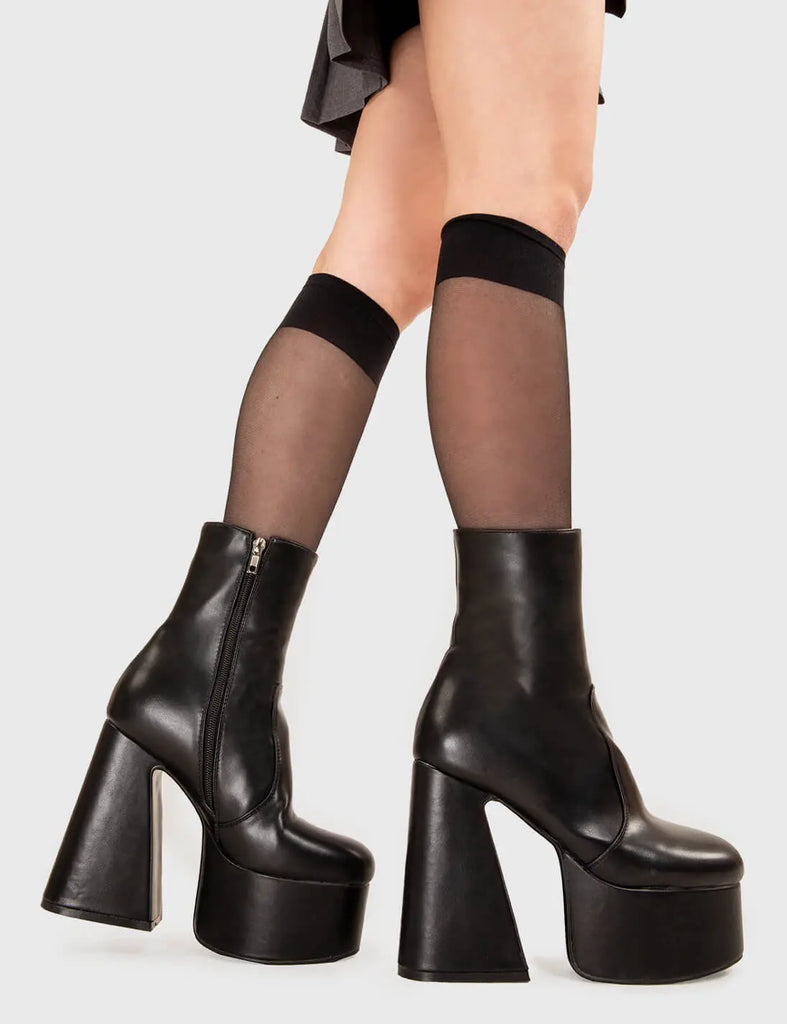 NOT YOUR AVERAGE BOOT Under Cover Platform Ankle Boots in Black faux leather. These platform boots feature a minimalist look with a flared heel, keeping it nice and classy. Made with eco-friendly materials and 100% cruelty-free, these platform boots are as ethical as they are chic. - Platform Height - Ankle length - Flared heel - High Heel - 100% vegan SKU: LMF 3349 - BlackPU