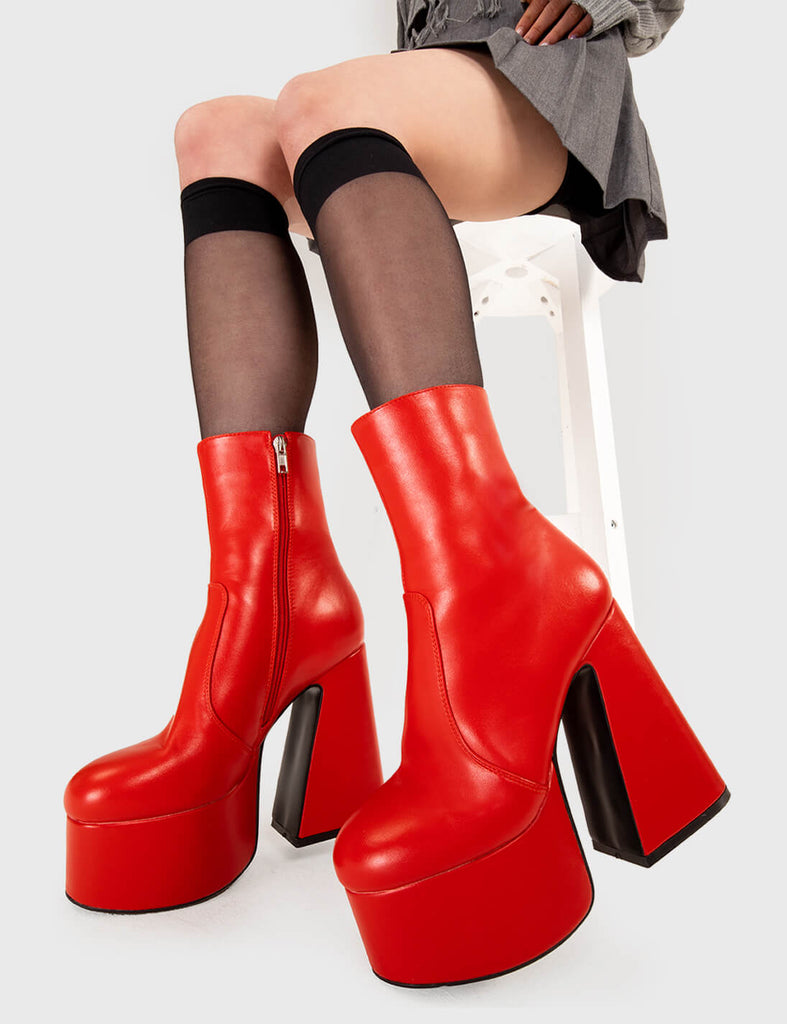 SMOOTH LIKE BUTTER Under Cover Platform Ankle Boots in Red faux leather. These platform boots feature a minimalist look with a flared heel, keeping it nice and classy. Made with eco-friendly materials and 100% cruelty-free, these platform boots are as ethical as they are chic. - Platform Height - Ankle length - Flared heel - High Heel - 100% vegan SKU: LMF 3349 - RedPU