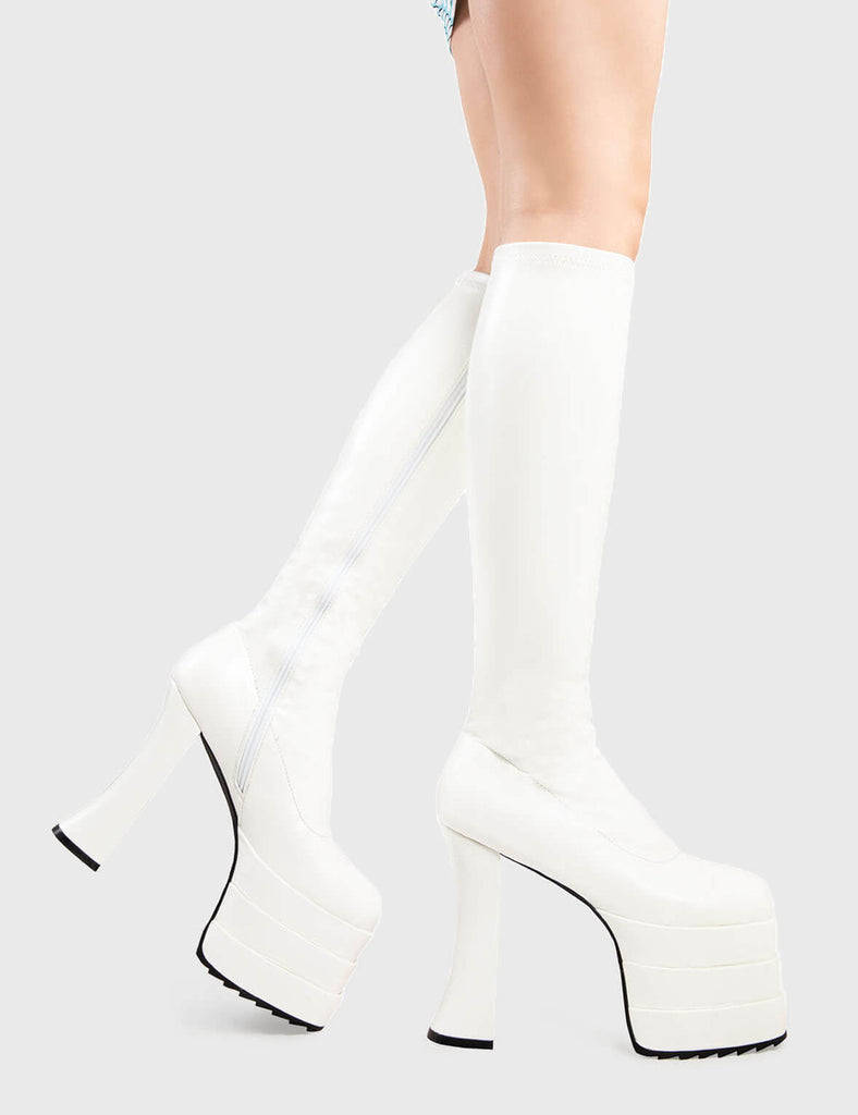 Trend Setter Unfaithful Promises Platform Knee High Boots in White faux leather. These platform boots feature an elegant, minimalist design with a curved heel on our triple-stack sole, the perfect way to elevate any look. Made with eco-friendly materials and 100% cruelty-free, these platform boots are as ethical as they are Trendy. - Platform Height - Heel Height - Stretchy - Curved Heel - Black Zip - Triple-stack Sole - Shark's teeth grip - Chunky Platform sole - 100% vegan SKU: LMF 2897 - WhitePU