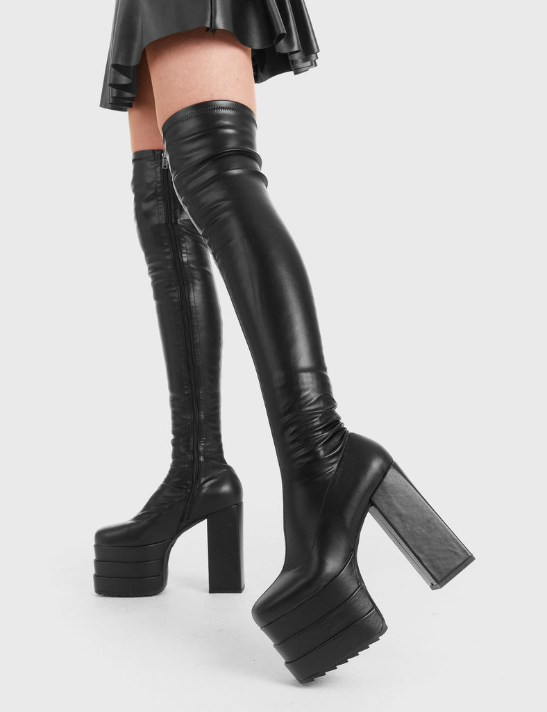 Eye-catching beauties! Walk Over Platform Thigh High Boots in Black faux leather. These platform boots feature a minimalist design with a fitted feel on our triple stack platform sole. Made with eco-friendly materials and 100% cruelty-free, these platform boots are as ethical as they are trendy. - Platform Height - Heel Height - Black zip - Fitted feel - High Heel - Triple Stack platform sole - 100% vegan SKU: LMF 3001 - BlackPU