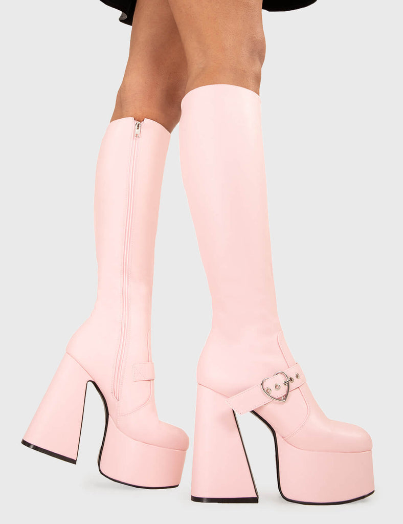 YOU STOLE MY HEART Walk With Love Platform Knee High Boots in Pink faux leather. These platform boots feature a minimalist look with a Flared heel, and an adjustable strap. Made with eco-friendly materials and 100% cruelty-free, these platform boots are as ethical as they are chic. - Platform Height - Knee high - Silver heart buckle - Flared heel - High Heel - 100% vegan SKU: LMF 3358 - PinkPU