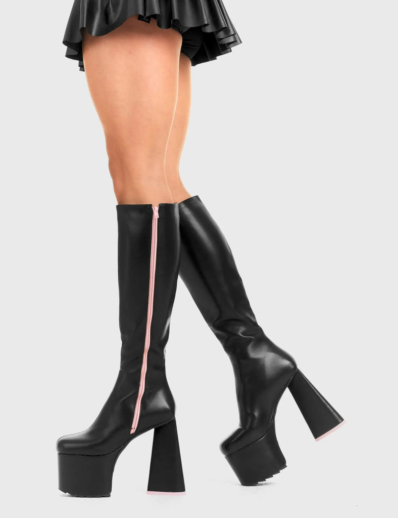 PEACE AND LOVE Wild Child Platform Knee High Boots in Black Faux Leather. These vegan western Boots feature heart shaped heel, with a red sole and shark teeth grips, very classy. Made with eco-friendly materials and 100% cruelty-free, these boots are as ethical as they are edgy! - Chunky Platform heels - Knee length - Shark teeth grip - Heart shaped heel - Pink heel sole - Rounded toe - 100% vegan SKU: LMF 3634 - BlackPU/Pink