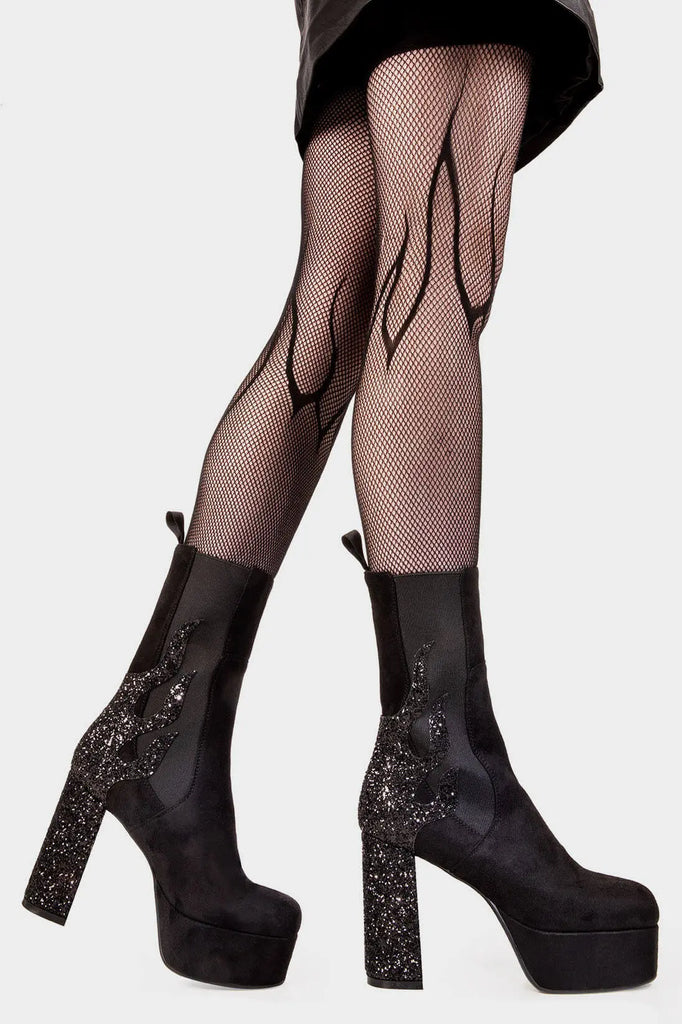 Burning Trails
  
 Apparent Lies Platform Calf Boots Boot in Black Suede. These black vegan Platform Boots feature black glitter flame detail to the back of the heel with a stretchy gusset detail, heat up your style game! Made with eco-friendly materials and 100% cruelty-free, these platform boots are as ethical as they are fiery!
 
 
 - Platform Height
 - Heel Height 
 - Gusset detail 
 - Wide calf and ankle friendly 
 - Platform Sole 
 - Round Toe
 - 100% vegan 
 
 SKU: LMF 2038 - BlackSUEDE/BlackGlitter