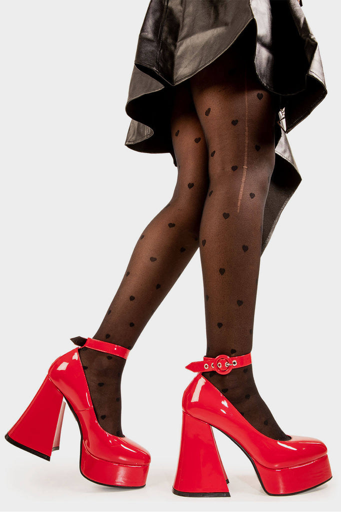 Elevated Elegance.

Build Me Up Platform Heels in Red Patent faux leather. These vegan Platform Heels feature a adjustable red patent ankle strap with a "O" ring buckle and silver eyelets, stepping into sophistication. Made with eco-friendly materials and 100% cruelty-free, these heels are as ethical as they are elegant!

- Platform Height: 2.6 inch
- Heel Height: 5.5 inch
- Adjustable red patent strap
- Silver eyelets 
- Platform sole
- Flared heel
- Round toe
- 100% vegan

SKU: LMF 1707 - RedPAT