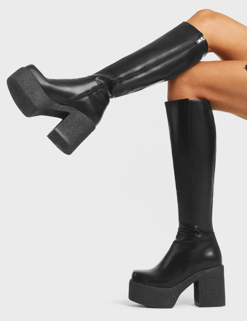 RED HANDED
 
 Called Out Chunky Platform Knee High Boots in Black faux leather. These platform boots feature a black minimalist design with a platformed chunky sole. Made with eco-friendly materials and 100% cruelty-free, these platform boots are as ethical as they are chic.
 
 - Platform Height
 - Knee high Length
 - Black Zip
 - Square Toe
 - Chunky Platform
 - 100% vegan 
 
 SKU: LMF 4098 - BlackPU