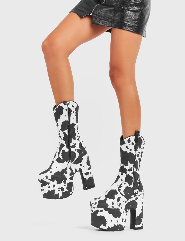 RINGING MEW
 
 Cowbell Chunky Platform Calf Boots in Cow Print faux suede. These vegan Platform Boots feature an ICONIC western cow print on a Chunky Platform sole and heel, the only choice for festival goers. Made with eco-friendly materials and 100% cruelty-free, these boots are as ethical as they are wild!
 
 
 - Platform Height: 
 - Heel Height:
 - Cowprint Design
 - Calf Length 
 - Black Zipper
 - Western Neck
 - Platform Sole
 - Pointed Toe
 - 100% vegan
 
 SKU: LMF 4921 - Cowprint