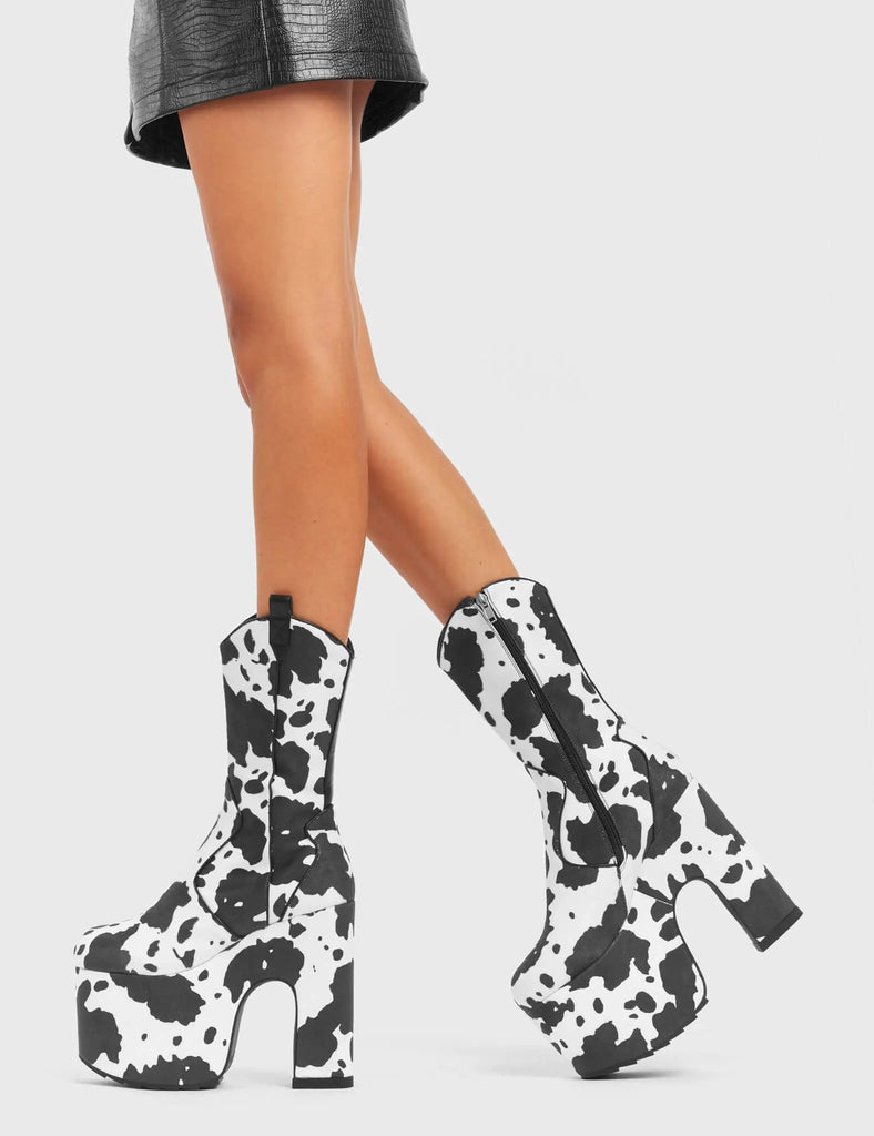 RINGING MEW
 
 Cowbell Chunky Platform Calf Boots in Cow Print faux suede. These vegan Platform Boots feature an ICONIC western cow print on a Chunky Platform sole and heel, the only choice for festival goers. Made with eco-friendly materials and 100% cruelty-free, these boots are as ethical as they are wild!
 
 
 - Platform Height: 
 - Heel Height:
 - Cowprint Design
 - Calf Length 
 - Black Zipper
 - Western Neck
 - Platform Sole
 - Pointed Toe
 - 100% vegan
 
 SKU: LMF 4921 - Cowprint
