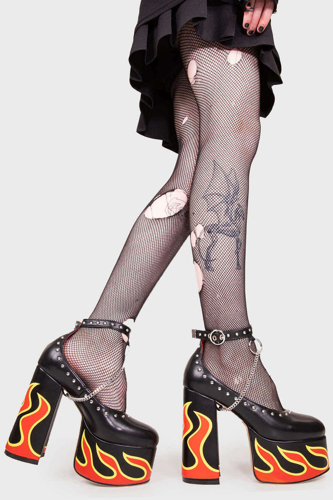 LIFE'S TOO SHORT FOR BORING HEELS
 
 Desire Platform Heels in Black faux leather. These vegan Platform Heels feature a flame print, silver studs and a high Platform sole and high heel, perfect for adding height, edge and glam to any outfit. Made with eco-friendly materials and 100% cruelty-free.
 
 - Platform Height: 2.5 inch
 - Heel Height: 5.5 inch
 - Silver studs & silver hanging chain
 - Adjustable ankle strap 
 - High platform sole
 - Round toe 
 - 100% vegan