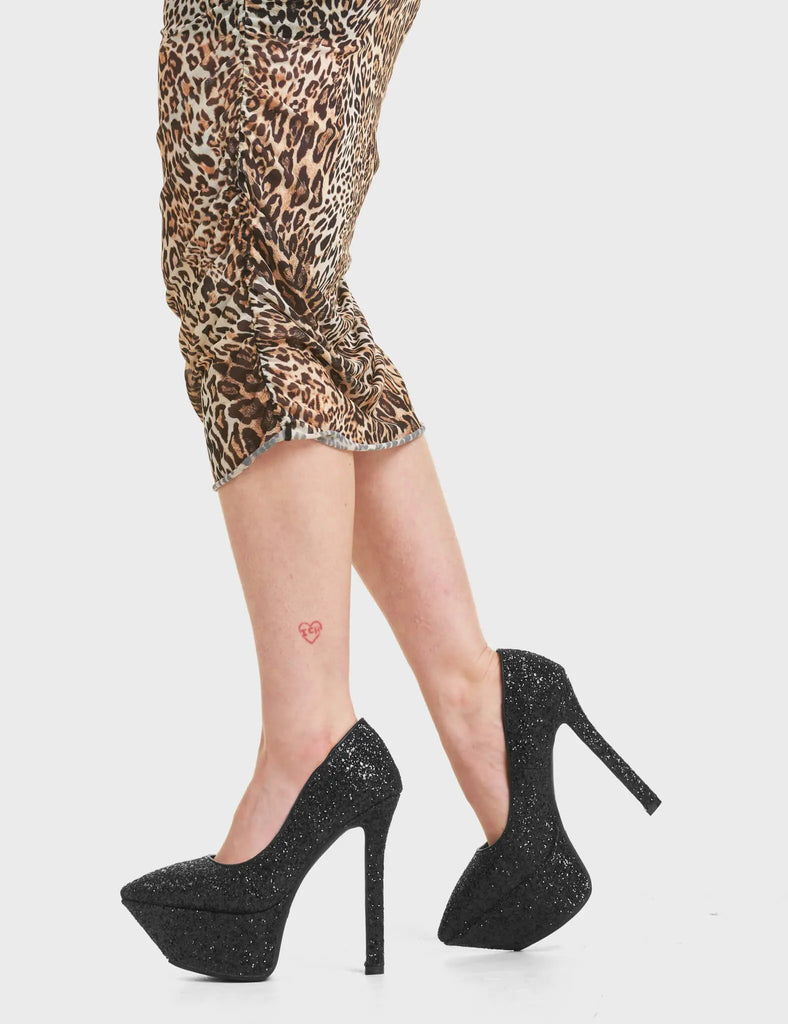 Diamond In The Rough Platform Heels in Black Glitter. Feature a simple and slick design with a pointed toe.
