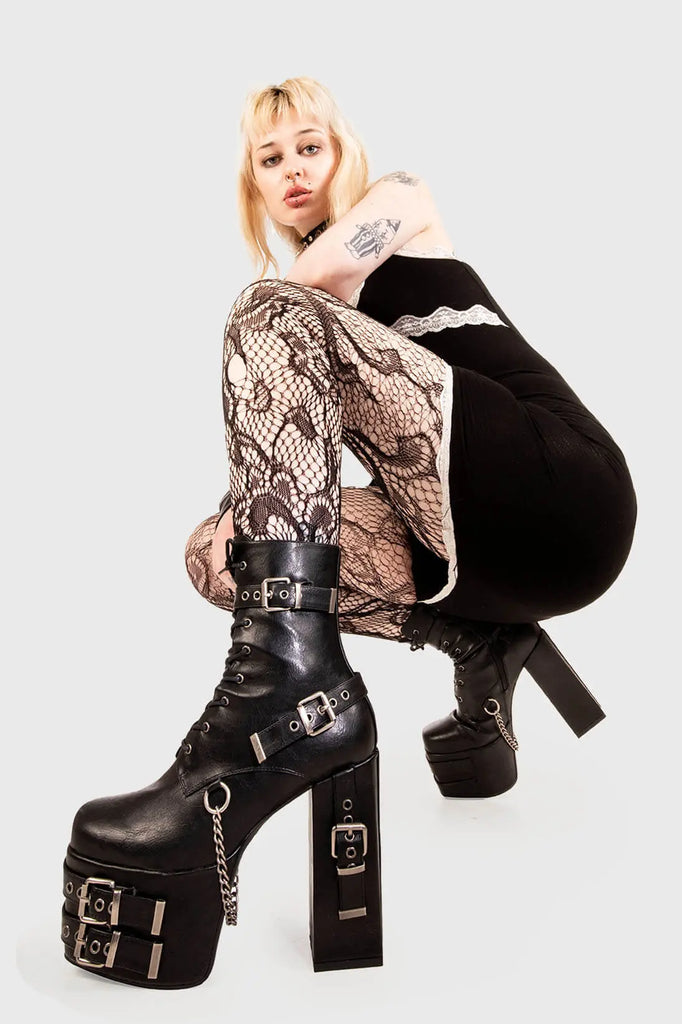 Strapped Up.
 
 Dilligence Chunky Platform Ankle Boots in Black faux leather. These Boots feature lace up detail with two adjustable straps around the ankle and three across the sole and heel. Made with eco-friendly materials and 100% cruelty-free
 
 - Platform Height: 2.5 inch
 - Heel Height: 5.5 inch 
 - Mid ankle length
 - Black zipper 
 - Black strap and silver eyelets
 - Square shaped buckles 
 - Silver chain
 - Chunky Platform sole
 - Round Toe
 - 100% vegan 
 
 SKU: LMF 1862 - BlackPU