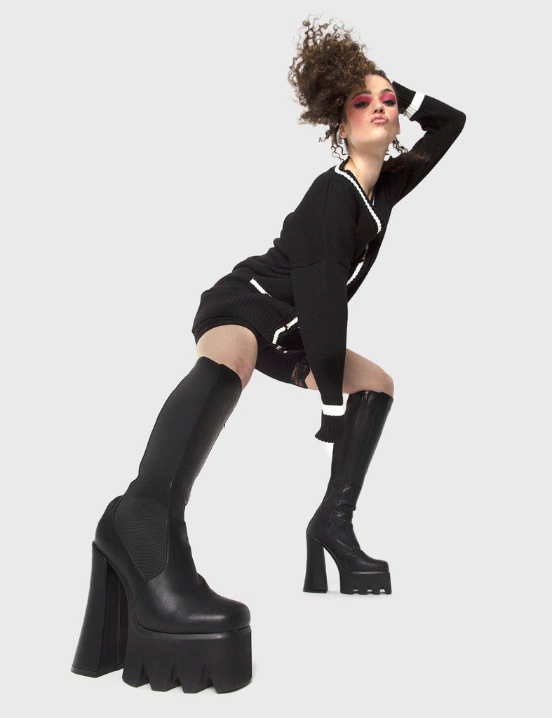 TIME TO LEVEL UP 
 
 Disco Inferno Platform Knee High Boots in Black faux leather. These vegan Knee High Boots feature an elastic gusset and a high platform sole, making them the perfect comfy Boots for any occasion. Made with eco-friendly materials and 100% cruelty-free.
 
 
 - Platform Height: 2.2 inch
 - Heel Height: 6 inch 
 - Wide ankle friendly
 - Wide calf friendly
 - Knee high length
 - Black elastic gusset
 - Black zipper
 - Platform sole
 - Round toe 
 - 100% vegan 
 
 SKU: LMF 1011 - BlackPU