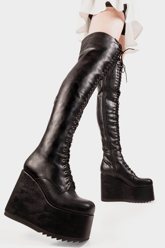 Edge Walkers
 
 Don't Fold Chunky Platform Thigh High Boot in Black faux leather. These black vegan Platform Boots feature on our chunky platform wedge sole with adjustable lace up detail and silver eyelets, let the boots do the talking. Made with eco-friendly materials and 100% cruelty-free.
 
 
 - Platform Height: 1.8 inch
 - Heel height: 5.5 inch 
 - Black Zipper
 - Black laces 
 - Silver eyelets 
 - Chunky Platform wedge sole
 - Shark's teeth grip
 - S Tquareoe
 - 100% vegan 
 
 SKU: LMF 2070 - BlackPU