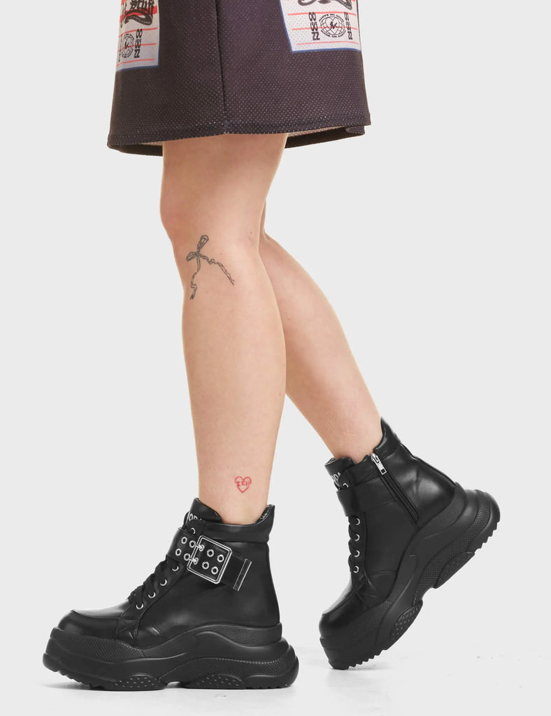 Eerie Chunky Platform Sneakers in Black with 'LAMODA' in white on the tongue of the shoe.