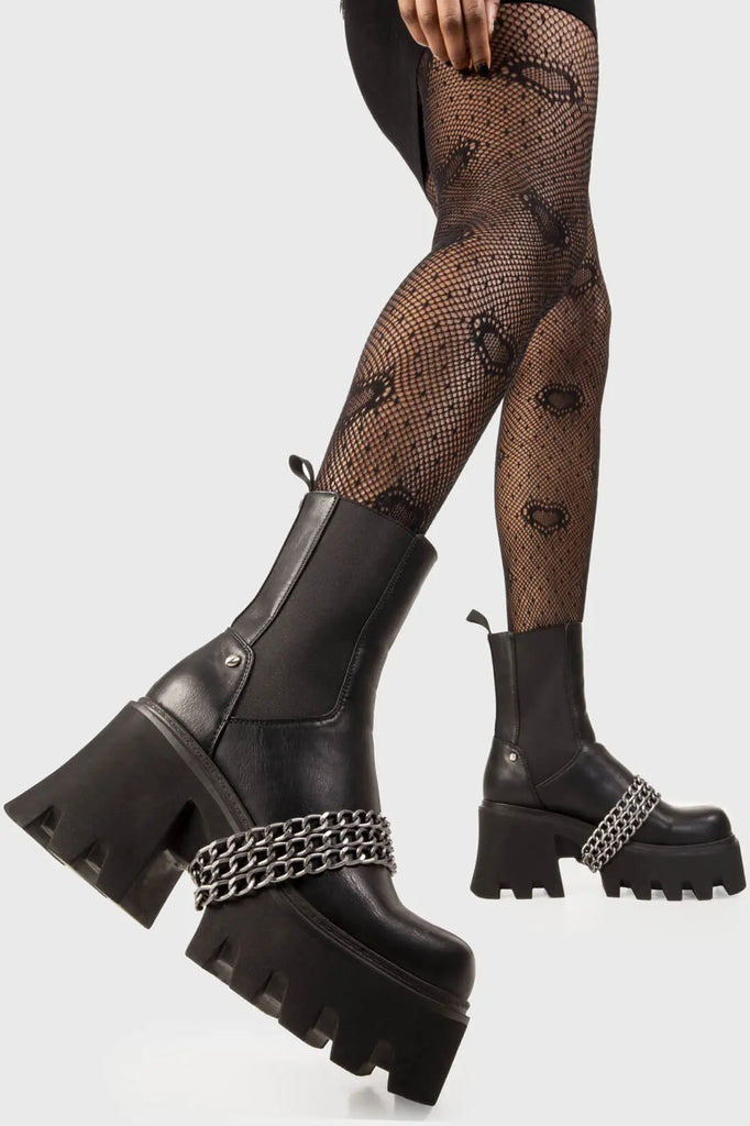 Chain Fever 
 
 Evening Stroll Chunky Platform Ankle Boots in Black faux leather. These black platform boots feature three silver chains across the upper with a stretchy gusset detail, ignite your presence. Made with eco-friendly materials and 100% cruelty-free, these platform boots are as ethical as they are Amazing!
 
 - Platform Height
 - Stretchy gusset detail
 - Wide ankle and calf friendly
 - Three silver chains
 - Chunky Platform sole
 - Round Toe 
 - 100% vegan 
 
 SKU: LMF 2250 - BlackPU