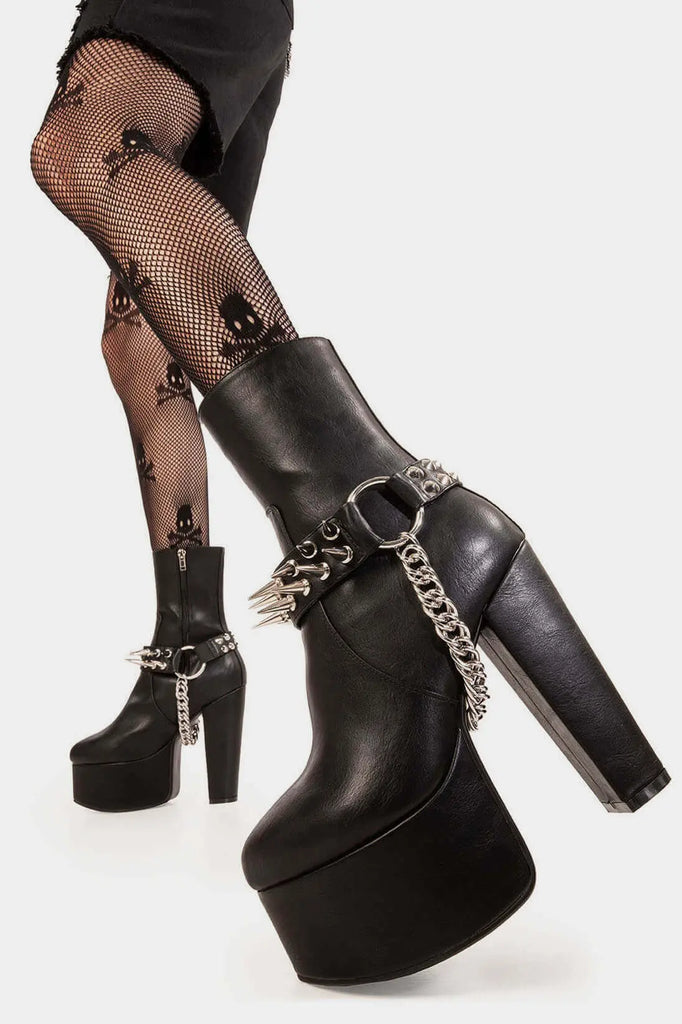 Rise of the Platforms
 
 Flashbacks Platform Ankle Boots in Black faux leather. These vegan Platform Ankle Boots feature a Platform sole with a black ankle strap and silver spiked studs with a silver hanging chain, unleash your confidence! Made with eco-friendly materials and 100% cruelty-free.
 
 
 - Platform Height: 2.5 inch
 - Heel Height: 5.5 inch 
 - Black strap with silver spiked studs 
 - Silver chain 
 - Mid ankle length 
 - High Platform sole
 - Round toe
 - 100% vegan 
 
 SKU: LMF 0371 - BlackPU