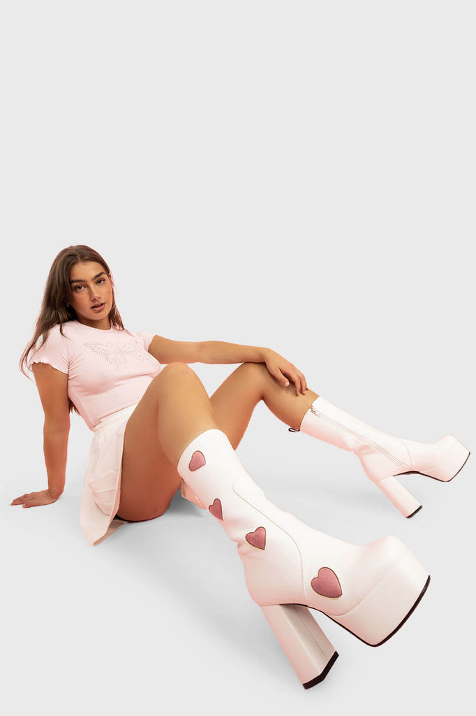 LOVE AT FIRST SIGHT

Game Of Love Platform Calf Boots in White faux leather. These Pink vegan Boots feature our ICONIC Pink faux suede hearts and Platform sole and heel, perfect for adding height and style to any outfit. Made with eco-friendly materials and 100% cruelty-free, these boots are as ethical as they are cute!


- Platform Height: 1.25 inch
- Heel Height: 4.2 inch
- Calf High length
- Pink Hearts
- Whote zipper 
- Platform sole
- Round Toe
- 100% vegan 

SKU: LMF 1213 - WhitePU/PinkHeart