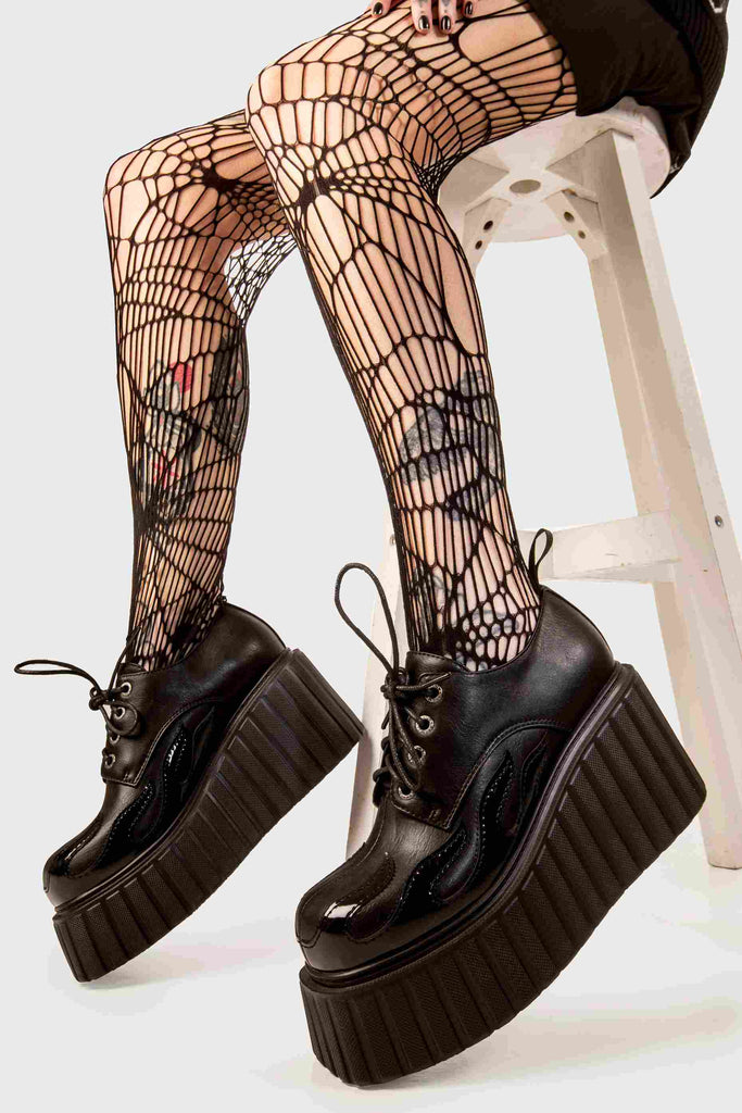 Blaze Runner
 
 Girls On Tour Chunky Platform Creeper Shoes in Black. These black creeper shoes feature a patent black flame across the side of the shoe, stepping on flames and setting hot trends. Made with eco-friendly materials and 100% cruelty-free, these platform boots are as ethical as they are HOT!
 
 - Platform Height
 - Black Laces with black eyelets
 - Patent black flame 
 - Chunky creeper wedge sole
 - Round Toe 
 - 100% vegan 
 
 SKU: LMF 2222 - Black/Flame