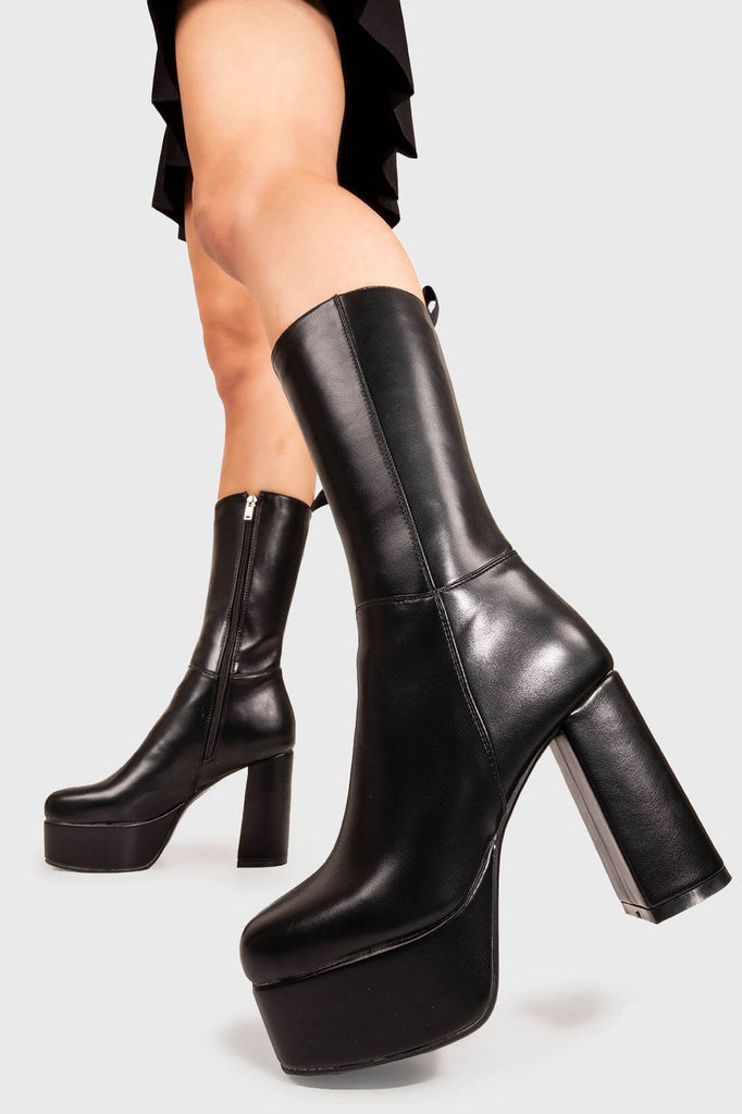 THE TIMELESS ONE
 
 Going Under Platform Calf Boots in Black faux leather. These Black vegan Boots feature an elegant, minimalist design and a Platform sole and heel, perfect for adding height and style to any outfit. Made with eco-friendly materials and 100% cruelty-free, these boots are as ethical as they are stylish.
 
 
 - Platform Height: 1.25 inch
 - Heel Height: 4.2 inch
 - Calf High length
 - Black zipper 
 - Platform sole
 - Round toe 
 - 100% vegan 
 
 SKU: LMF 1209 - BlackPU