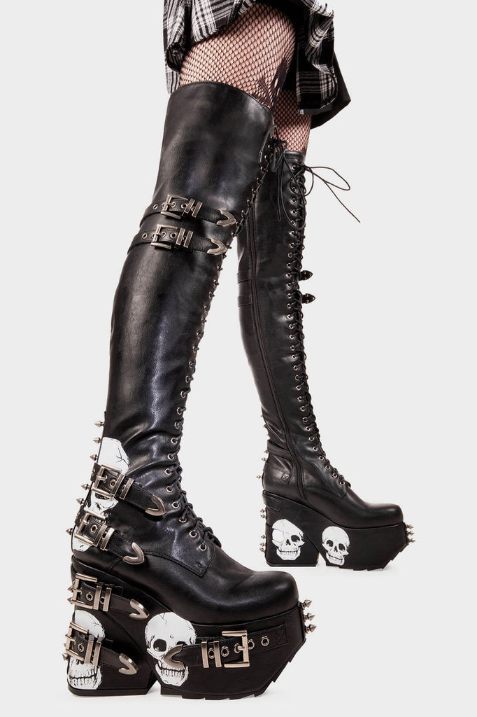 Savage Stompers
 
 Irrational Thoughts Chunky Platform Thigh High Boots in Black faux leather. These black vegan Platform Boots feature our iconic skull print throughout the sole and up the heel with adjustable black lace up detail on our chunky platform sole, stomp with savage.
 
 
 - Platform Height
 - Heel Height 
 - Black Zipper
 - Adjustable black lace up detail
 - Skull print 
 - Silver square shaped buckles with silver eyelets 
 - Silver spiked studs 
 
 
 SKU: LMF 2075 - Black/Skull