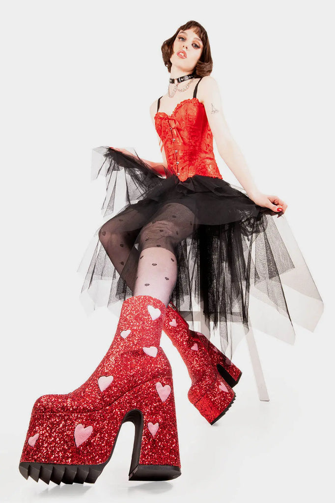 Fairy Dust
 
 Keeper Chunky Platform Ankle Creeper Boot in Red Glitter. These red vegan Platform Boots feature our iconic glitter detail throughout with pink suede hearts, leave a trail of sparkle and make every step a dazzling statment Made with eco-friendly materials and 100% cruelty-free.
 
 
 - Platform Height
 - Heel Height 
 - Red zipper 
 - Pink suede hearts 
 - Chunky Creeper sole
 - Shark's teeth grip
 - Round Toe
 - 100% vegan 
 
 SKU: LMF 2047 - RedGlitter/PinkHeart