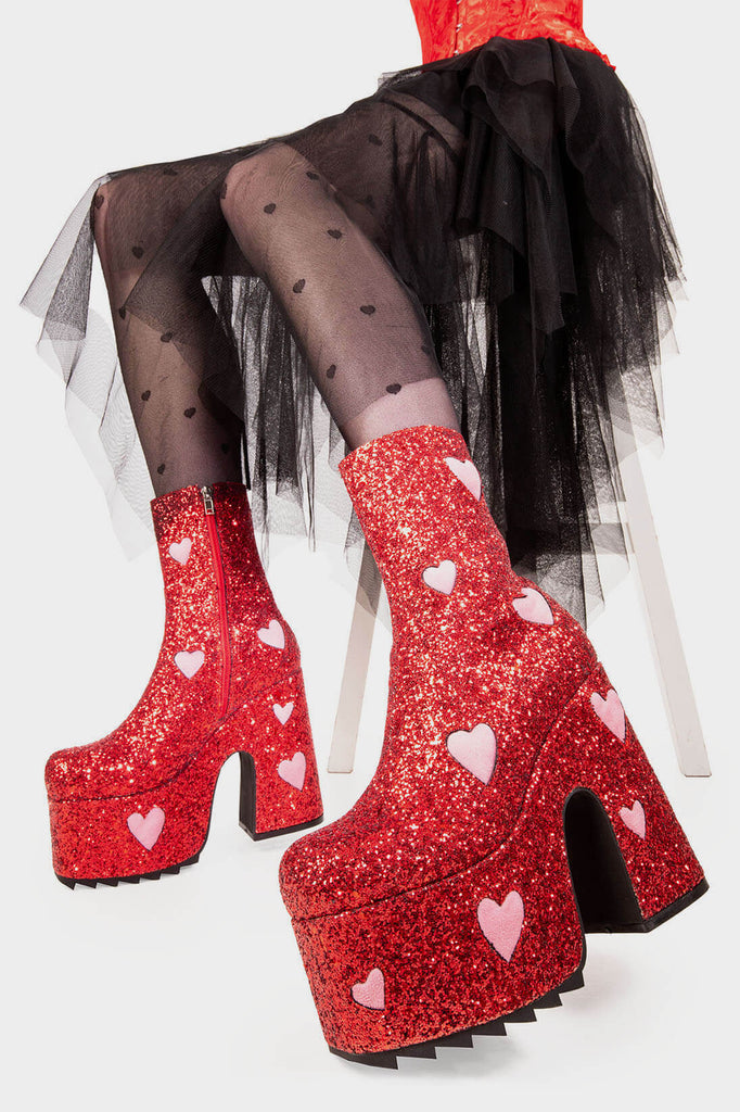 Fairy Dust
 
 Keeper Chunky Platform Ankle Creeper Boot in Red Glitter. These red vegan Platform Boots feature our iconic glitter detail throughout with pink suede hearts, leave a trail of sparkle and make every step a dazzling statment Made with eco-friendly materials and 100% cruelty-free.
 
 
 - Platform Height
 - Heel Height 
 - Red zipper 
 - Pink suede hearts 
 - Chunky Creeper sole
 - Shark's teeth grip
 - Round Toe
 - 100% vegan 
 
 SKU: LMF 2047 - RedGlitter/PinkHeart