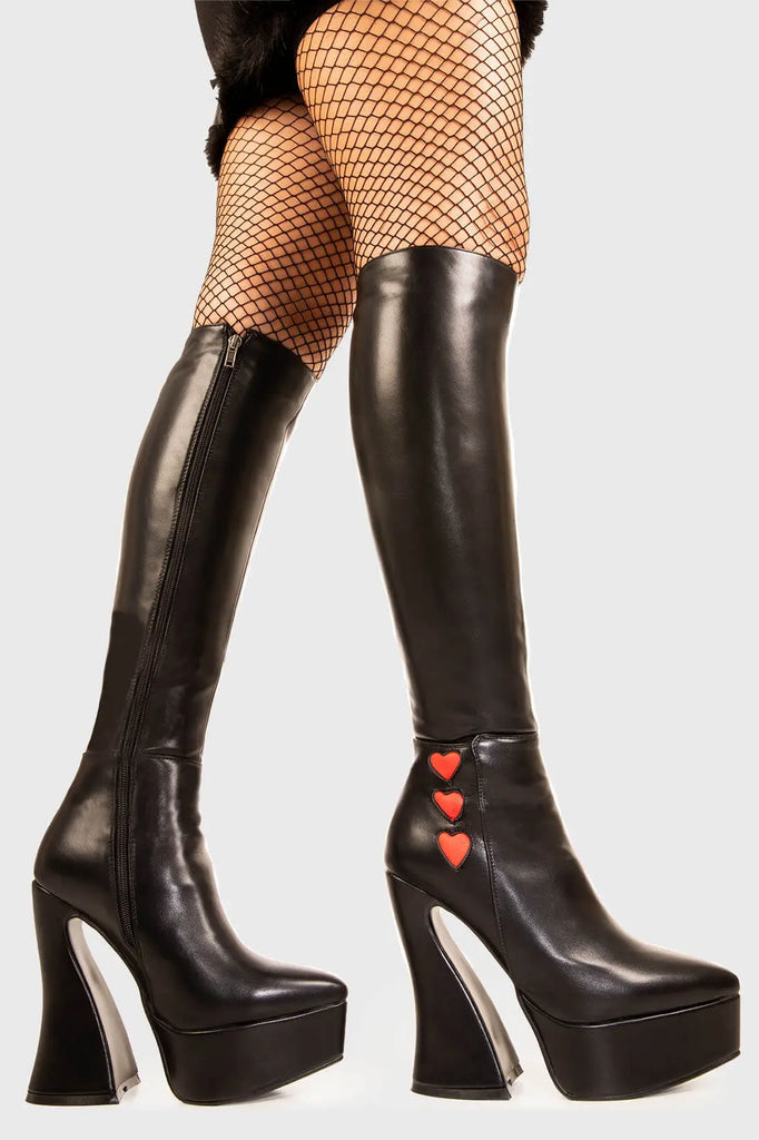 Lovestruk

Love Potion Platform Knee High Boots in Black faux leather. These black vegan Platform Boots feature three red suede hearts on the outter on our platform sole, elevating your style with love. Made with eco-friendly materials and 100% cruelty-free, these platform boots are as ethical as they are heart warming!


- Platform Height: 1.4 inch
- Heel Height: 5 inch
- Flared heel
- Black zipper 
- Red suede hearts 
- Chunky Platform sole
- Round Toe
- 100% vegan 

SKU: LMF 1900 - BlackPU/RedHeart - UK3