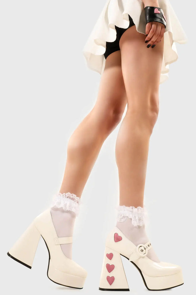 Cupid is here 
 
 Love Sick Platform Heels in Black Patent faux leather. These vegan Platform Heels feature pink patent hearts on the heel and side of the shoe with a adjustable black strap, Heels that speak the language of love. 
 
 - Platform Height: 2.6 inch
 - Heel Height: 5.5 inch
 - Ajustable strap 
 - "O" ring shaped buckles and silver eyelets
 - Pink Patent hearts 
 - Platform sole
 - Flared heel
 - Round toe 
 - 100% vegan
 
 SKU: LMF 1709 - WhitePAT/PinkHeart