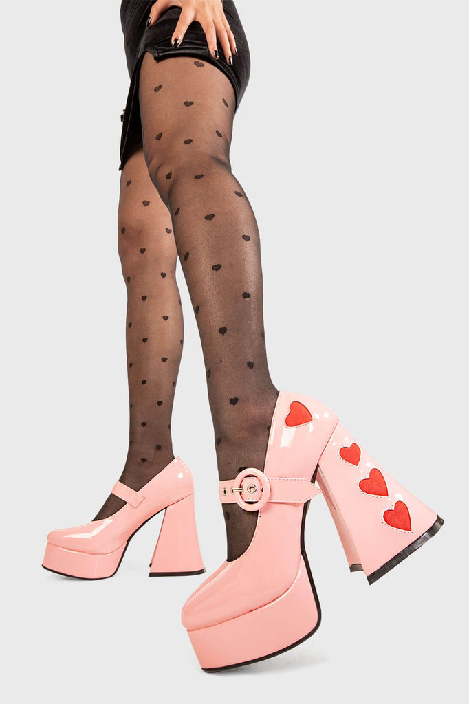 Cupid is here 
 
 Love Sick Platform Heels in Black Patent faux leather. These vegan Platform Heels feature pink patent hearts on the heel and side of the shoe with a adjustable black strap, Heels that speak the language of love. 
 
 - Platform Height: 2.6 inch
 - Heel Height: 5.5 inch
 - Ajustable strap 
 - "O" ring shaped buckles and silver eyelets
 - Pink Patent hearts 
 - Platform sole
 - Flared heel
 - Round toe 
 - 100% vegan
 
 SKU: LMF 1709 - PinkPAT/RedHeart