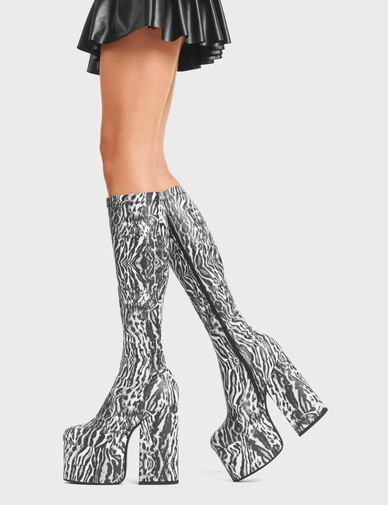 Messenger Platform Knee High Boots in Tiger print. Feature a minimalist design, platform sole and a stretch fit.