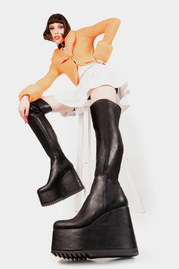 Peak Perfection
 
 Never Again Chunky Platform Thigh High Boot in Black faux leather. These black vegan Platform Boots feature on our chunky platform wedge sole, let the boots do the talking. Made with eco-friendly materials and 100% cruelty-free, these platform boots are as ethical as they are Perfect!
 
 
 - Platform Height
 - Black Zipper
 - Chunky Platform wedge sole
 - Shark's teeth grip
 - Round Toe
 - 100% vegan 
 
 SKU: LMF 2069 - BlackPU