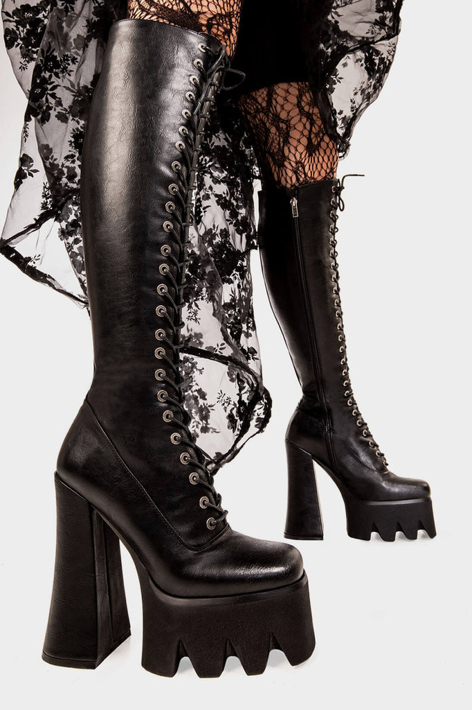 Lacey Dreams
  
 No Promises Platform Knee High Boots in Black faux leather . These black vegan Platform Boots feature adjustable lace up detail with silver eyelets,. Made with eco-friendly materials and 100% cruelty-free, these platform boots are as ethical as they are Dreamy!
 
 
 - Platform Height: 2.2 inch
 - Heel Height: 6 inch 
 - Black zipper
 - Black laces with silver eyelets 
 - Chunky Platform sole
 - Round Toe
 - 100% vegan 
 
 SKU: LMF 1992 - BlackPU