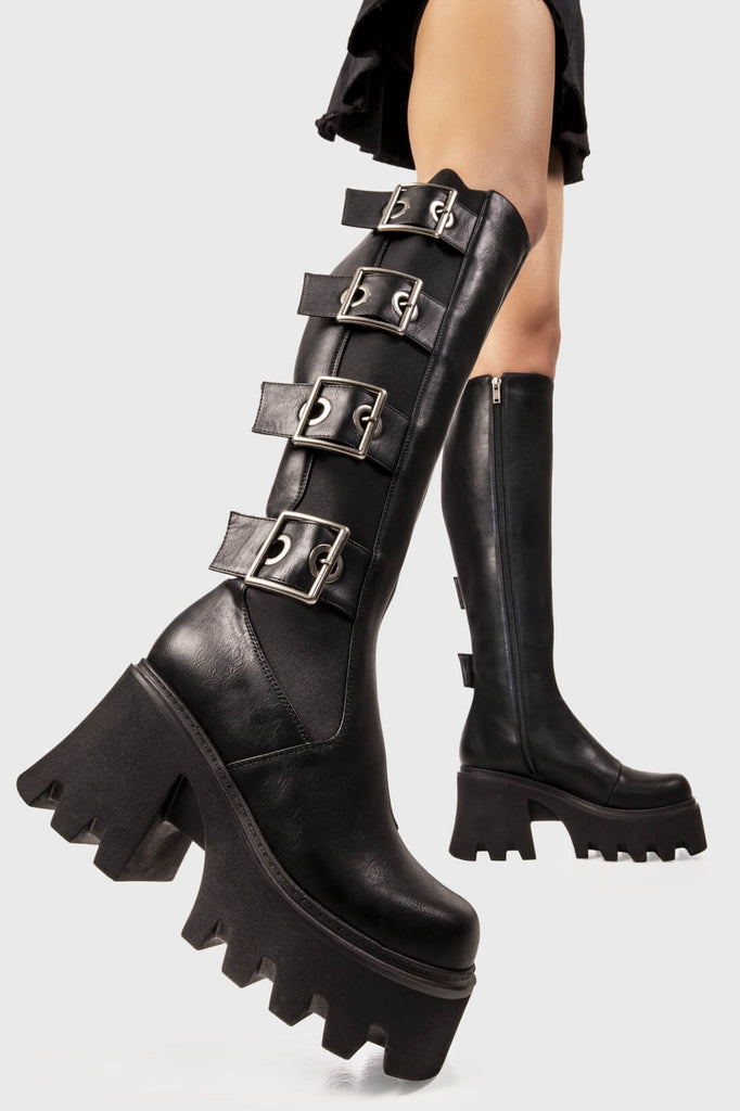 Just can't get enough! 
 
 Orion's Belt Chunky Platform Knee High Boots in Black faux leather. These black platform boots feature four large black straps with square shaped buckles and silver eyelets, make heads turn with these knee high boots. 
 
 - Platform Height
 - Knee high lengh
 - Stretchy gusset detail
 - Black Zipper 
 - Wide ankle and calf friendly
 - Fourt black straps with square shaped buckles 
 - Chunky Platform sole
 - Round Toe 
 - 100% vegan