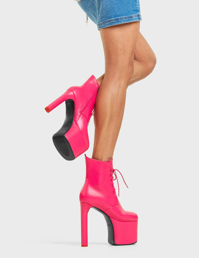 REVOLUTION

Prom Queen Platform Ankle Boots in Fuchsia faux leather. These platform boots feature a functional side zip and a lace-up design, the perfect way to elevate any outfit. Also features a heart shaped heel with a red heart at the bottom. Made with 100% vegan materials, these platform boots are as ethical as they are eye-catching.

- Platform Height: 6 CM
- Heel Height: 14 CM
- Lace-up Design
- Fuchsia zip
- High Heel
- Pointed toe
- Shark's Teeth Grip
- 100% vegan

SKU: LMF 4640 - FuchsiaPU
