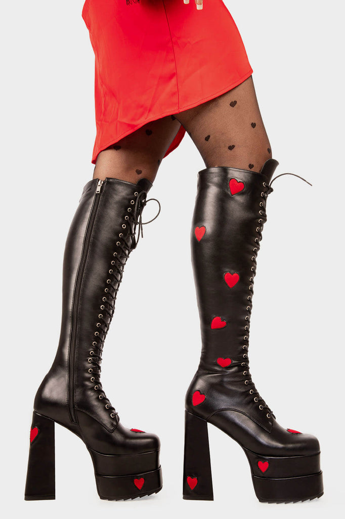 Trend Setters
 
 Pucker Up Platform Knee High Boots in Black. These black vegan Platform boots feature red suede hearts throughout and adjustable lace up detail with silver eyelets, setting trends one step at a time. Made with eco-friendly materials and 100% cruelty-free, these platform boots are as ethical as they are Setting trends!
 
 
 - Platform Height
 - Heel Height
 - Black Zipper 
 - Shark's teeth rubber grip 
 - Chunky platform sole
 - Square Toe
 - 100% vegan 
 
 SKU: LMF 2152 - Black/RedHeart