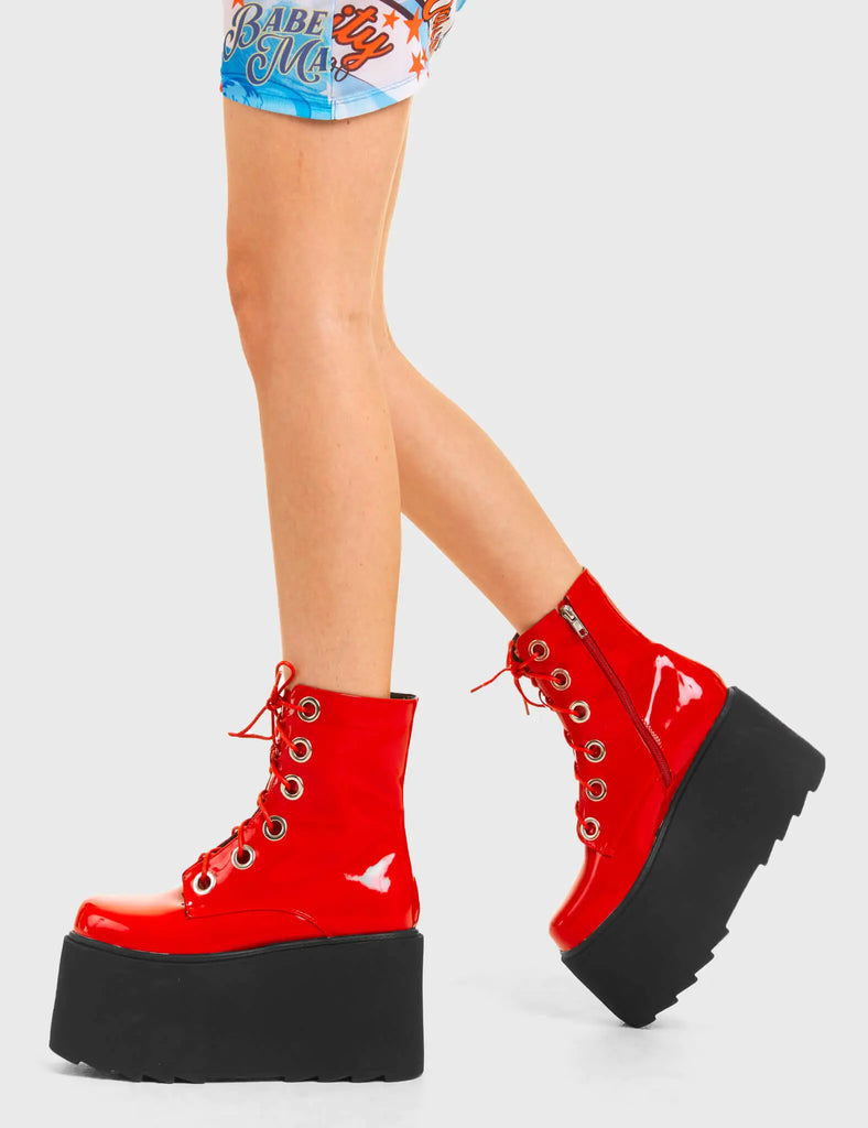 ELEVATED 
 
 Renegade Chunky Platform Ankle Boots in Red patent. These vegan western Boots feature silver eyelets and a shark teeth grip sole, very edgy. Made with eco-friendly materials and 100% cruelty-free, these boots are as ethical as they are Chic!
 
  
 - Chunky Platform
 - Ankle length
 - Shark teeth grip
 - Red Laces
 - Rounded toe 
 - 100% vegan 
 
 SKU: LMF 3746 - RedPAT