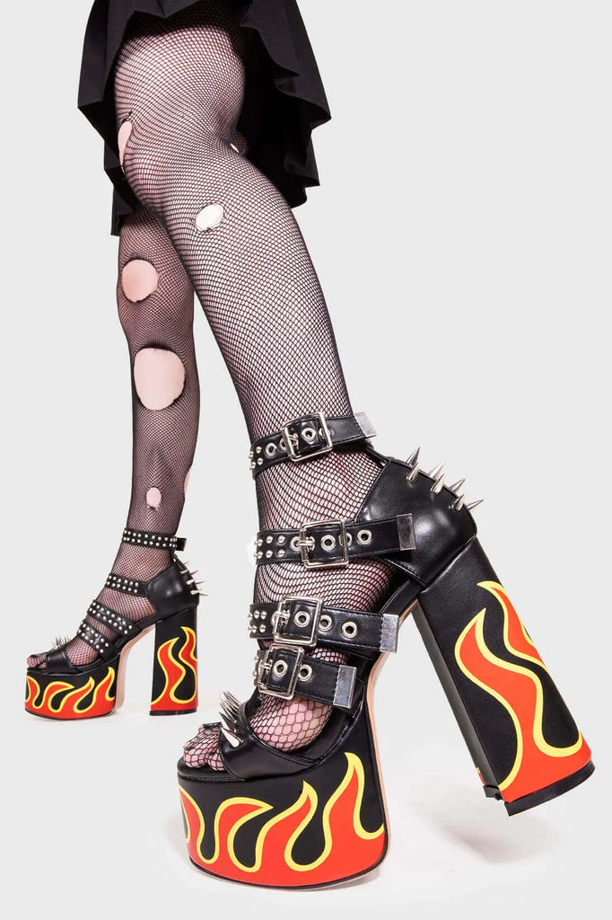 IT'S ALL IN THE DETAILS!
 
 Revin' Plaform Sandals in Black faux leather. These vegan Platform Sandals feature a flame print, silves spikes with a Platform sole and high heel, perfect for adding height and glamour to any outfit. Made with eco-friendly materials and 100% cruelty-free, these Sandals are as ethical as they are badass!
 
 
 - Platform Height: 2.5 inch
 - Heel Height: 5.5 inch 
 - Open Toe
 - Flame print
 - Adjustable ankle straps
 - Silver spikes & studs
 - High Platform sole
 - Round toe