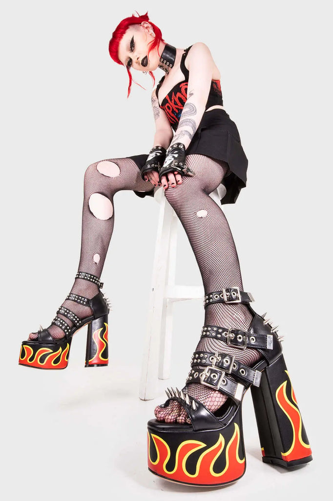 IT'S ALL IN THE DETAILS!
 
 Revin' Plaform Sandals in Black faux leather. These vegan Platform Sandals feature a flame print, silves spikes with a Platform sole and high heel, perfect for adding height and glamour to any outfit. Made with eco-friendly materials and 100% cruelty-free, these Sandals are as ethical as they are badass!
 
 
 - Platform Height: 2.5 inch
 - Heel Height: 5.5 inch 
 - Open Toe
 - Flame print
 - Adjustable ankle straps
 - Silver spikes & studs
 - High Platform sole
 - Round toe