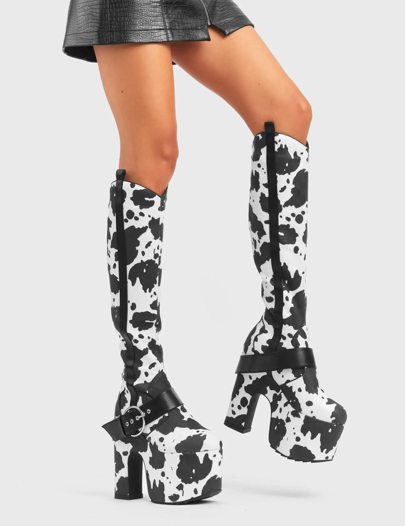 ANIMALISTIC
 
 Rhinestone Cowboy Chunky Platform Knee High Boots in Cow Print faux suede. These vegan Platform Boots feature an ICONIC western cow print on a Chunky Platform sole and heel, also features a adjustable strap across the front. Made with eco-friendly materials and 100% cruelty-free, these boots are as ethical as they are wild!
 
 
 - Platform Height: 
 - Heel Height: 
 - Cowprint Design
 - Knee High Length 
 - Black Zipper
 - Platform Sole
 - Pointed Toe
 - 100% vegan
 
 SKU: LMF 5118 - Cowprint