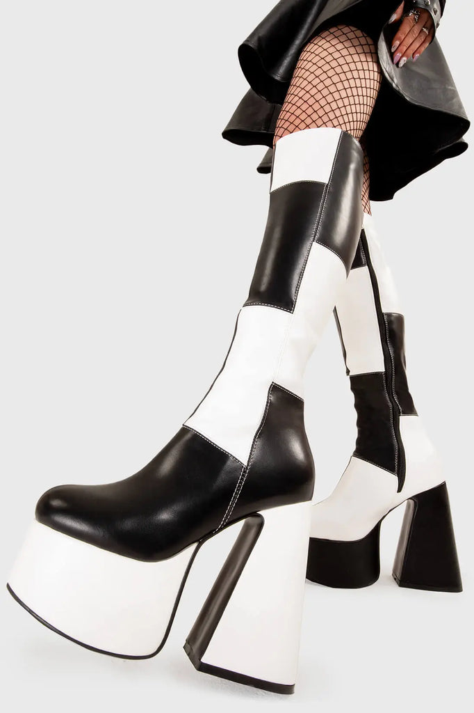 TIME TO DANCE
 
 Runway Platform Knee High Boots in Black and white faux leather. These platform boots feature a black and white patch work design with a triangle heel, keeping it nice and classy. Made with eco-friendly materials and 100% cruelty-free, these platform boots are as ethical as they are chic.
 
 - Platform Height
 - Knee high length
 - Patch work design
 - Triangle heel
 - High Heel
 - 100% vegan 
 
 SKU: LMF 3361 - BlackPU/WhitePU