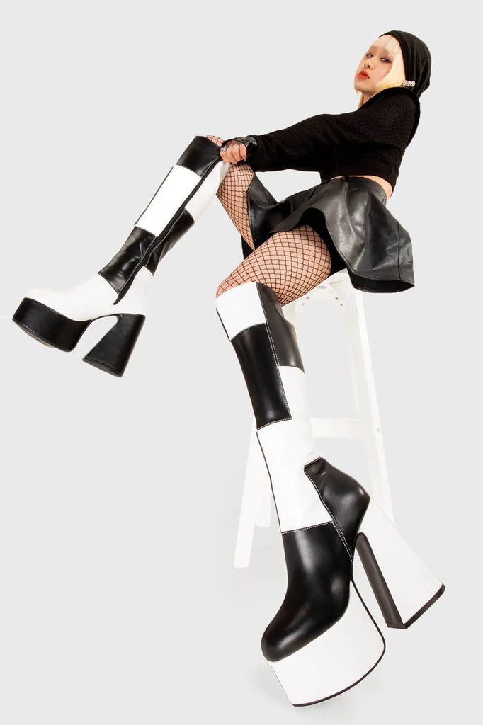 TIME TO DANCE
 
 Runway Platform Knee High Boots in Black and white faux leather. These platform boots feature a black and white patch work design with a triangle heel, keeping it nice and classy. Made with eco-friendly materials and 100% cruelty-free, these platform boots are as ethical as they are chic.
 
 - Platform Height
 - Knee high length
 - Patch work design
 - Triangle heel
 - High Heel
 - 100% vegan 
 
 SKU: LMF 3361 - BlackPU/WhitePU
