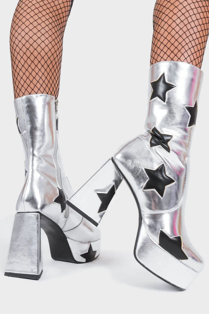 DISCO FEVER 
 
 Seeking Stars Platform Ankle Boots in silver faux leather. These platform boots feature a silver boot with black stars all over. Made with eco-friendly materials and 100% cruelty-free, these platform boots are as ethical as they are chic.
 
 - Platform Height
 - Black stars
 - Calf length
 - Triangle heel
 - High Heel
 - 100% vegan 
 
 SKU: LMF 3338 - SilverPU/BlackStar