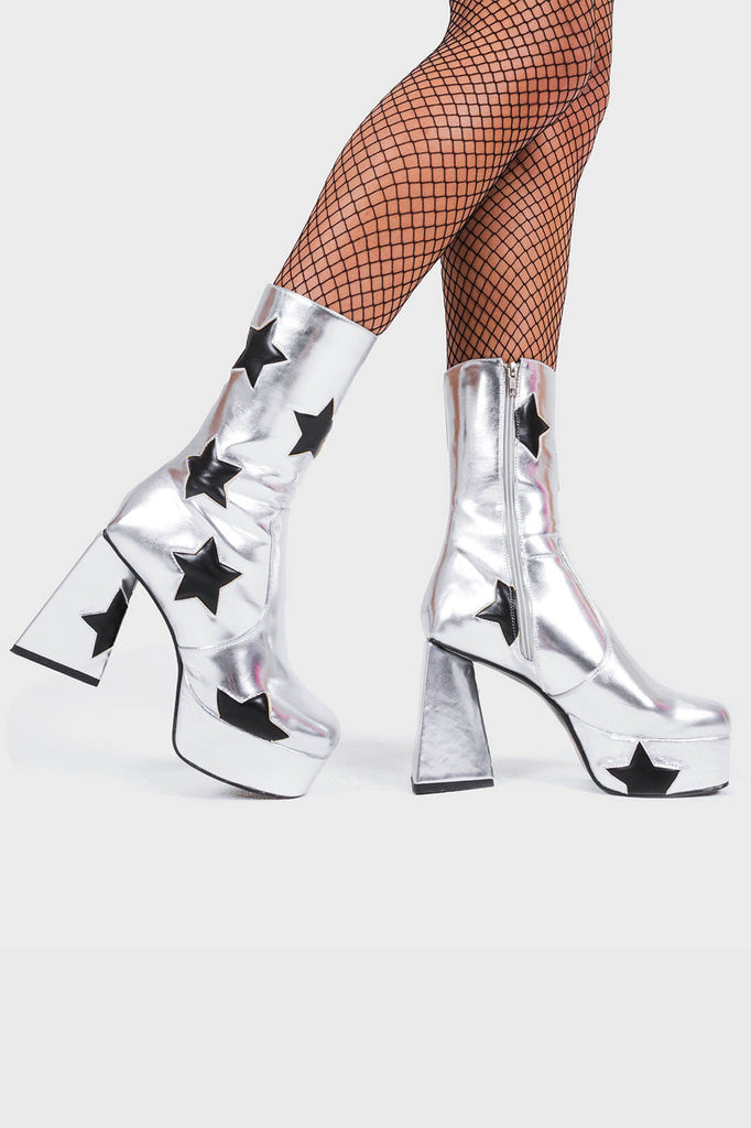 DISCO FEVER 
 
 Seeking Stars Platform Ankle Boots in silver faux leather. These platform boots feature a silver boot with black stars all over. Made with eco-friendly materials and 100% cruelty-free, these platform boots are as ethical as they are chic.
 
 - Platform Height
 - Black stars
 - Calf length
 - Triangle heel
 - High Heel
 - 100% vegan 
 
 SKU: LMF 3338 - SilverPU/BlackStar