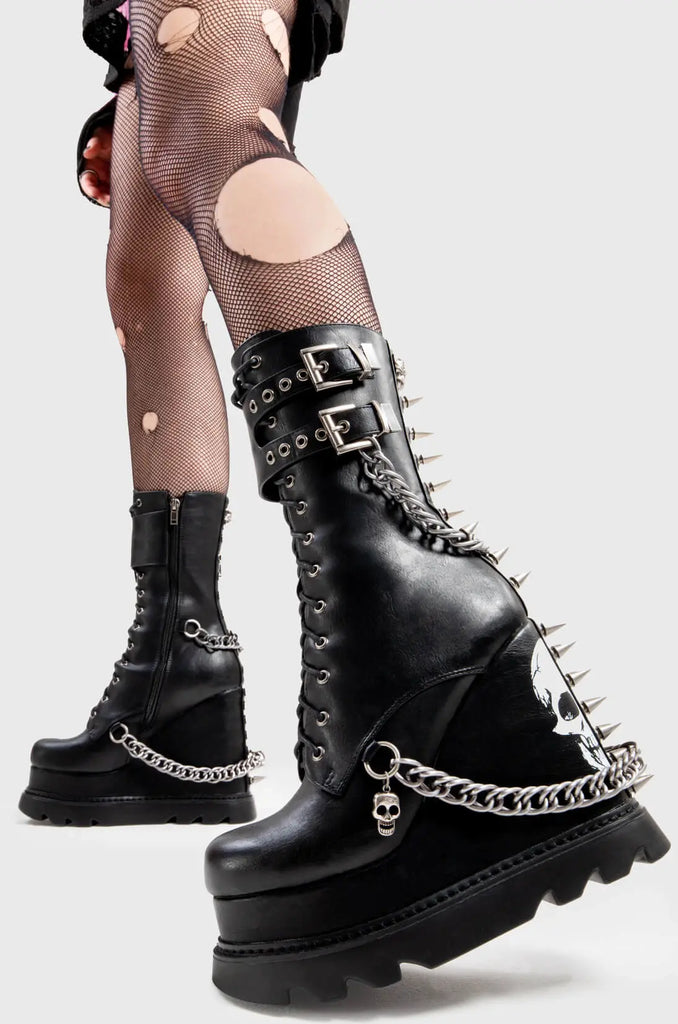 Creating Chaos
 
 She's Dangerous Chunky Platform Ankle Boots in Black faux leather. These Black vegan Wedge boots feature a skull print on our Platform wedge sole, with chains, buckles and spikes on the boots, perfect for adding height and edge to any look. Made with eco-friendly materials and 100% cruelty-free.
 
 
 - Platform Height: 
 - Heel Height
 - Silver Buckles
 - Silver Chains
 - Skull print
 - Spikes
 - Black Zip
 - Wedge sole
 - Round Toe
 - 100% vegan 
 
 SKU: LMF 2946 - Black/Skull
